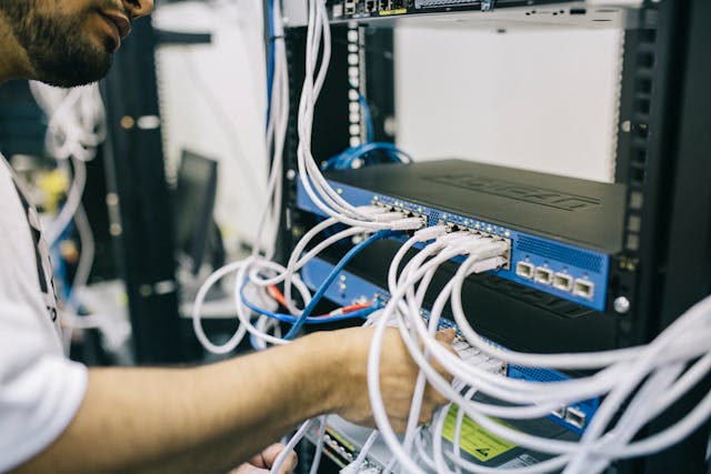 Electronics Engineer Fixing Cables on Server.jpg