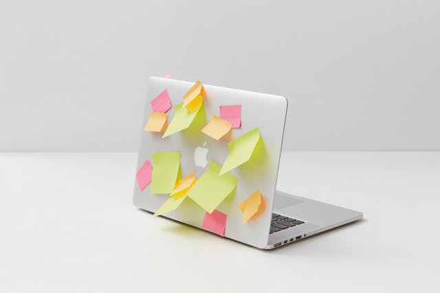 Yellow-Green-and-Pink-Sticky-Notes-on-Silver-Laptop.jpg